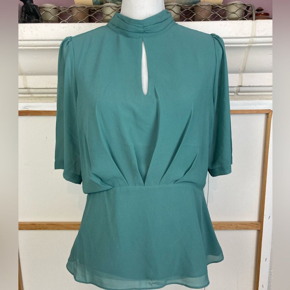 Naked Zebra sculptured Blouse w/ waist nip peplum & keyhole neckline & back